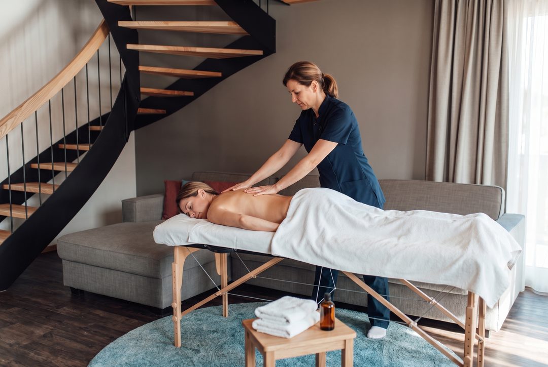 Massage i stuen i et chalet foran vindeltrappen, symbolbillede